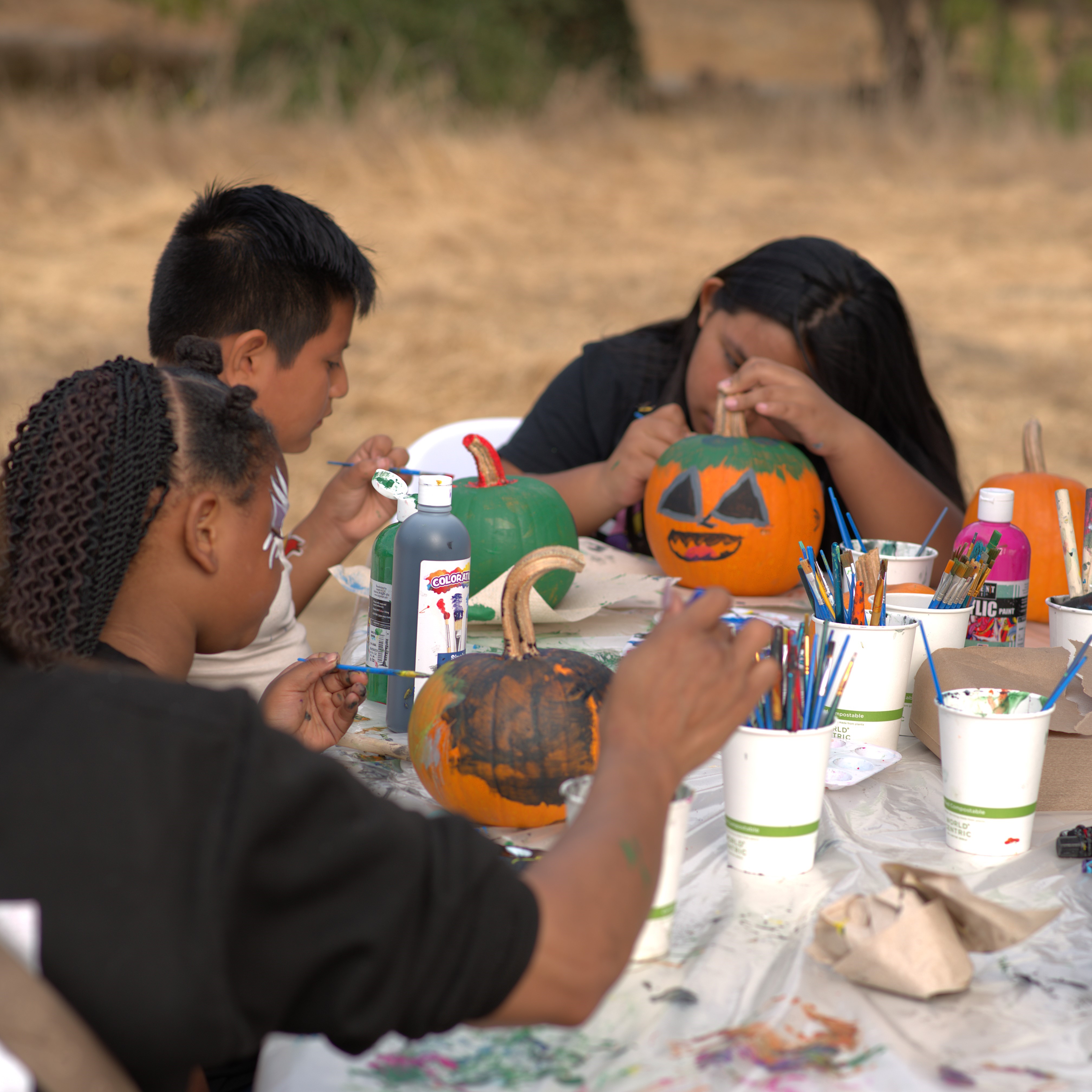 kids painting pumpkins